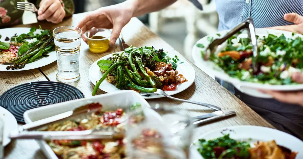 0 Cropped view of table laid with crockery and fresh homemade vegetarian food