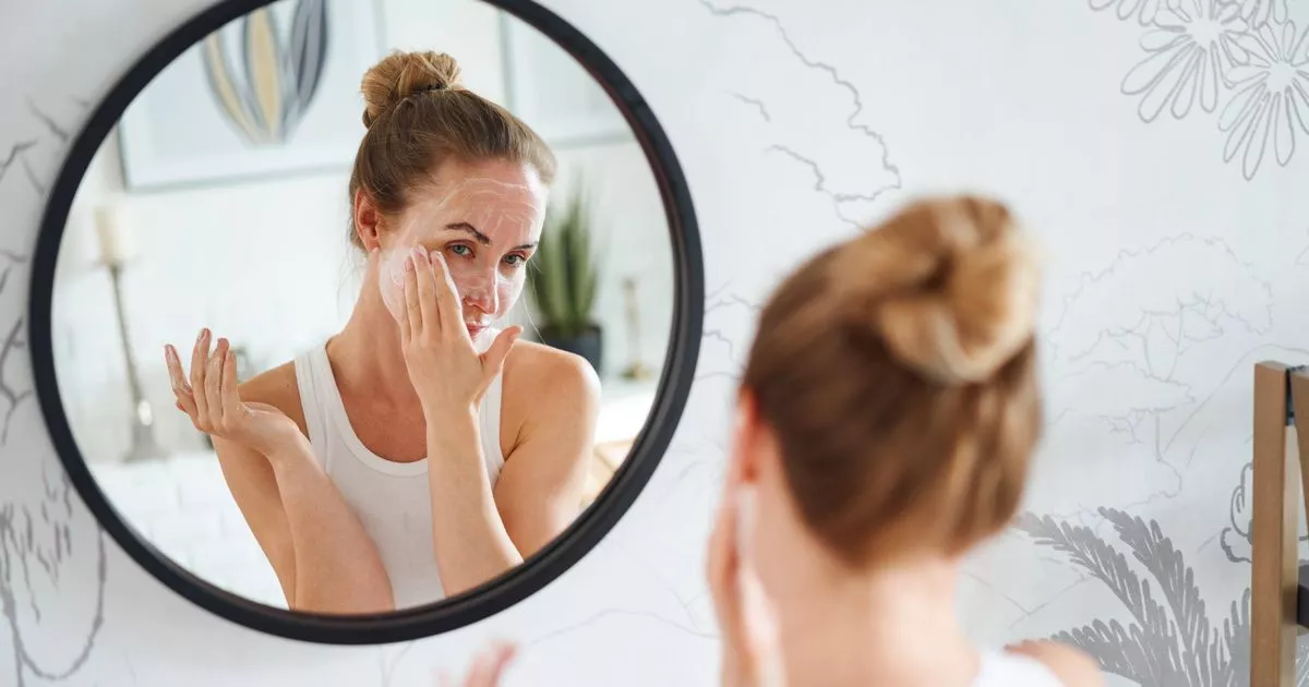 0 Woman cleaning face with cosmetic product