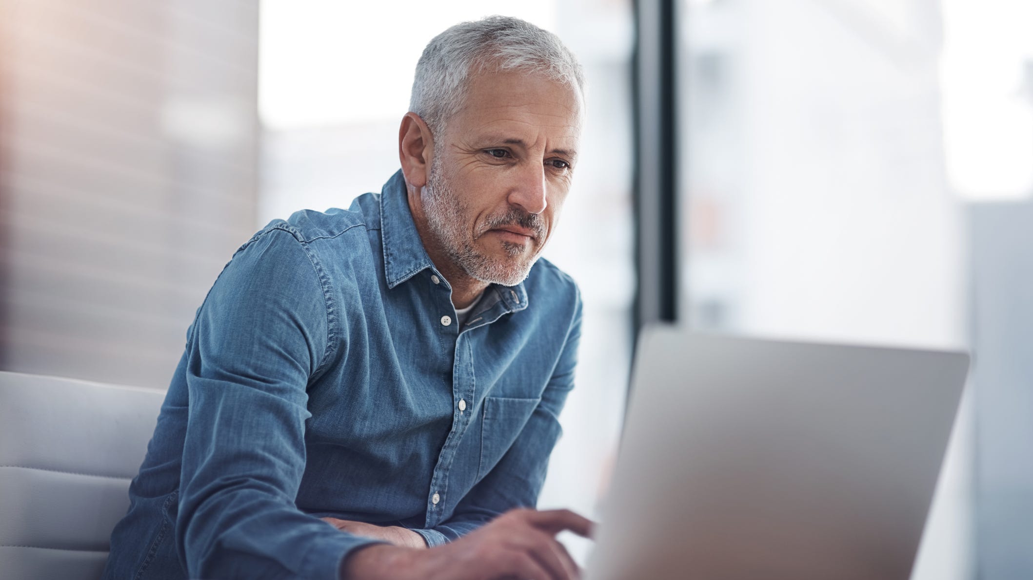 84162734007 older man at laptop gettyimages 623192890