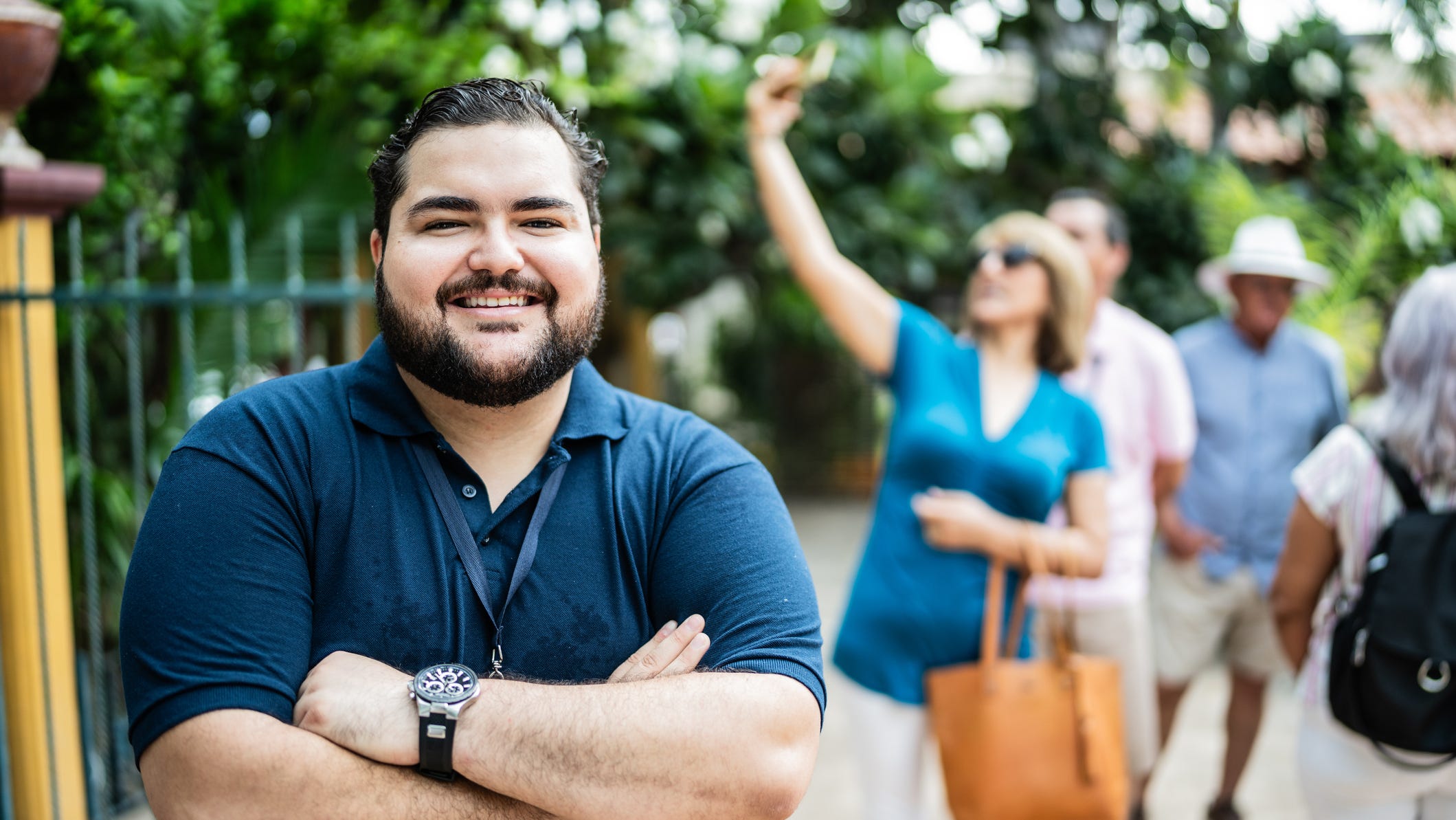84306386007 getty arms folded happy smiling outdoors