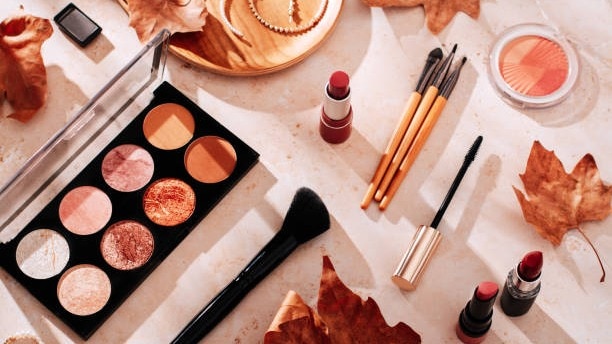 beauty products and makeup autumn leaves on beige background autumn skincare and autumn makeup con 181656442