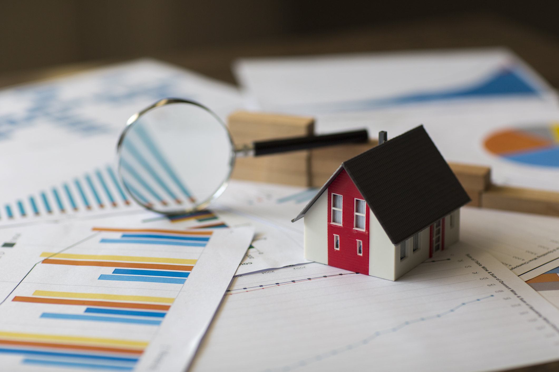 miniture house on a financial chart