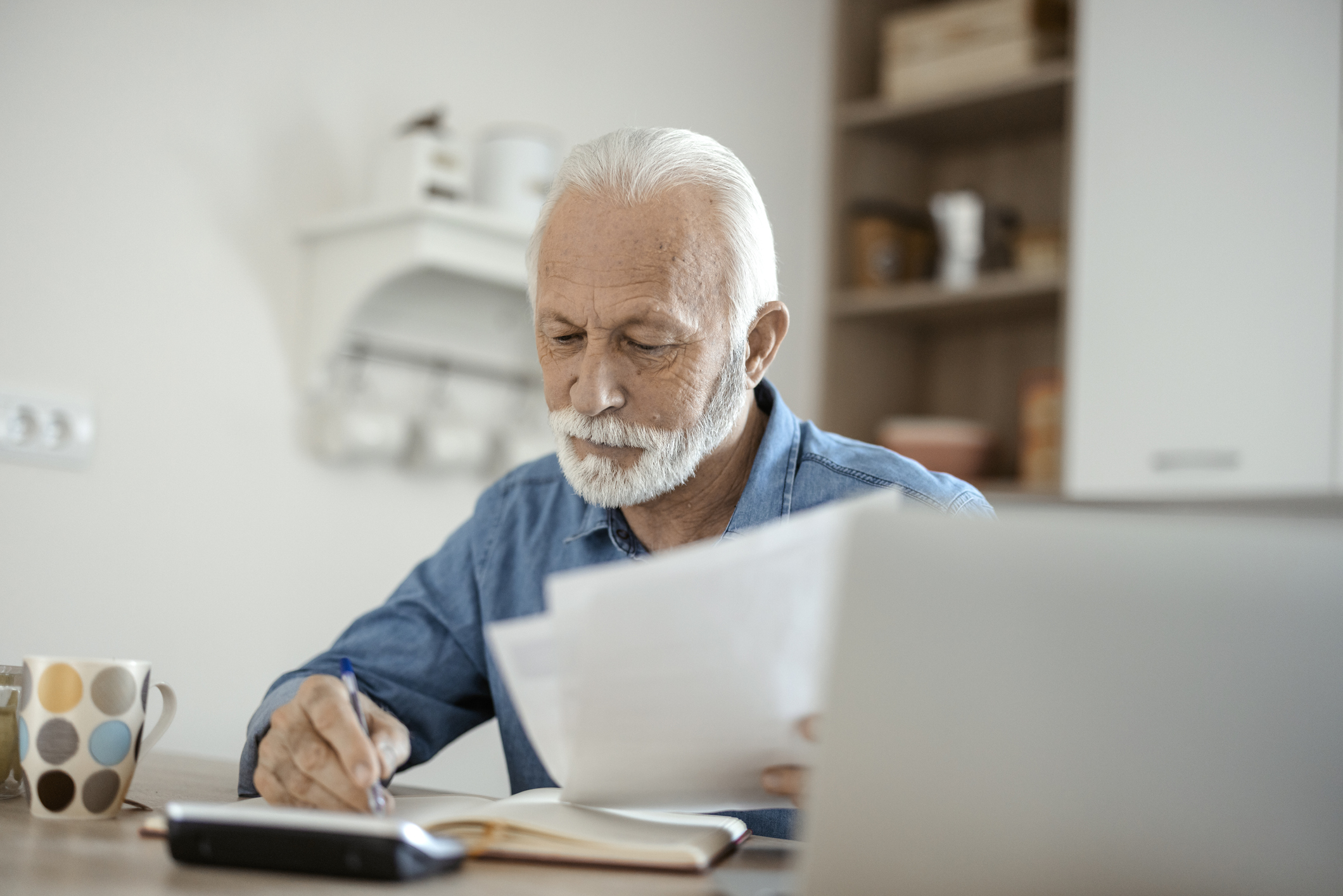 older man at desk serious gettyimages 1367292739
