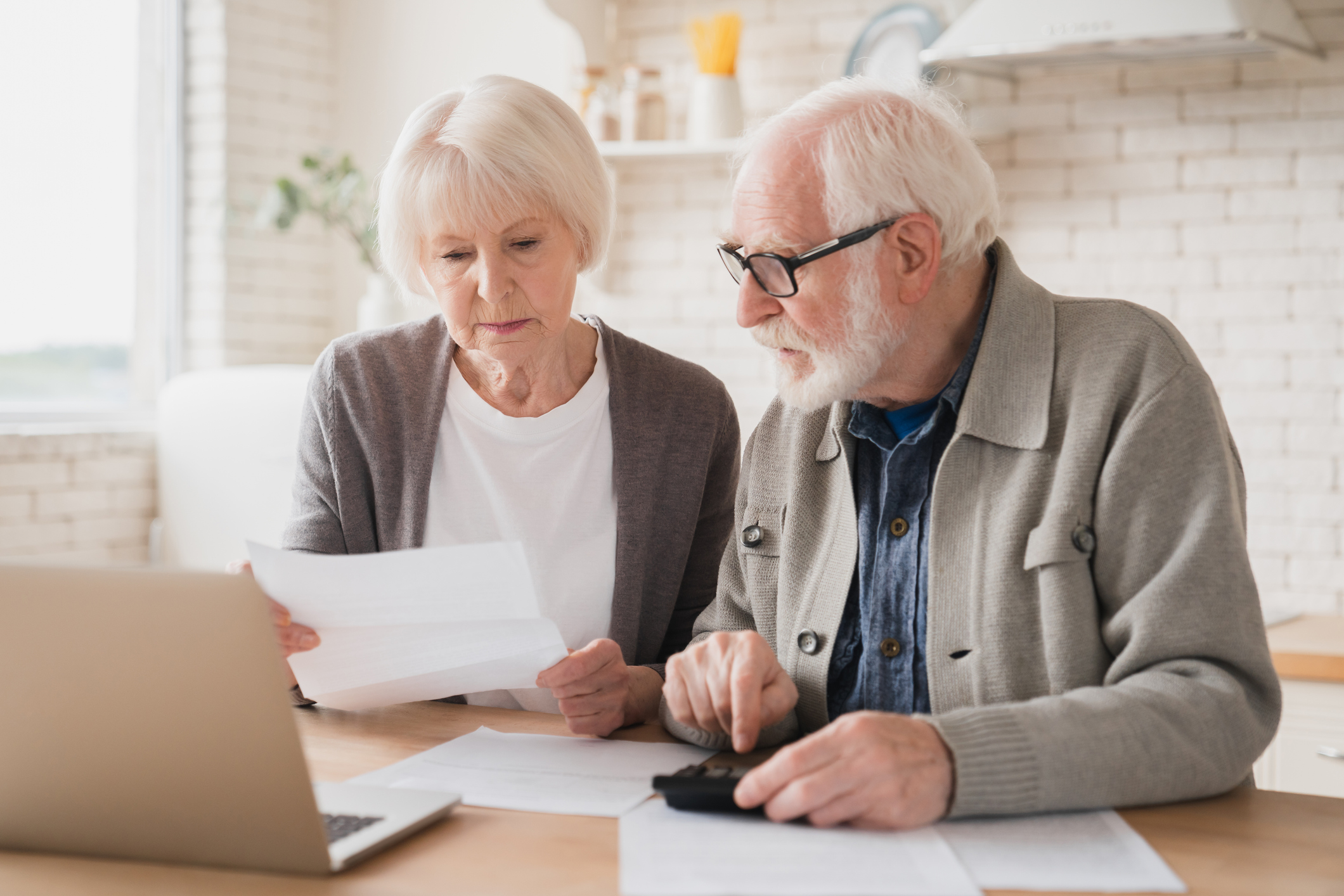 senior couple laptop documents gettyimages 1367867682