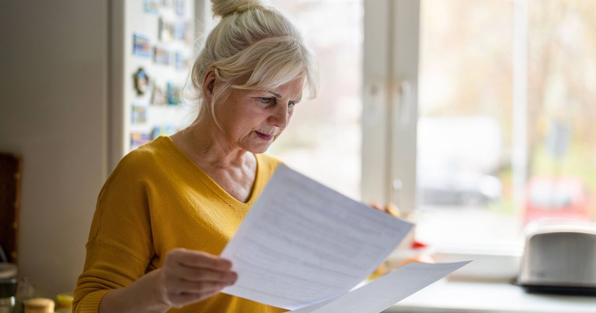 0 Senior woman filling out financial statements