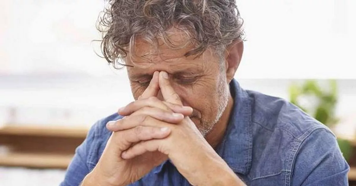 18 Stressed man looking at paperwork