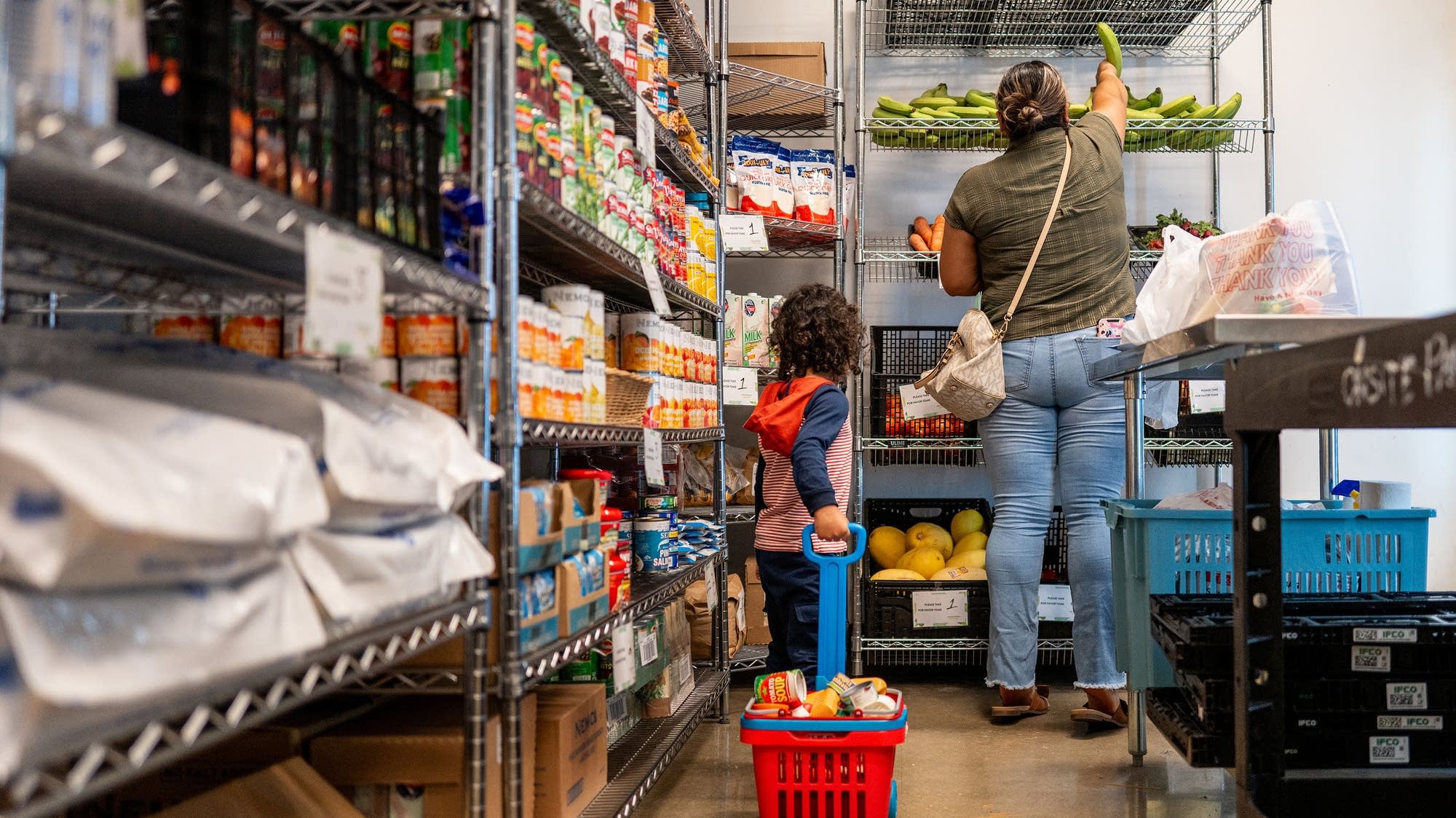 3a9c9d 20250708 a family gathers food in the community pantry at the central texas food bank 2000