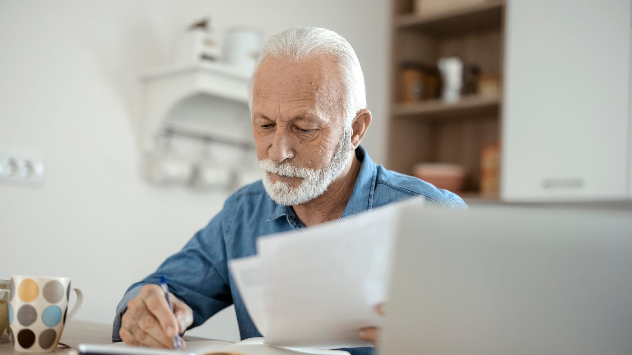 84746574007 older man at desk serious gettyimages 1367292739