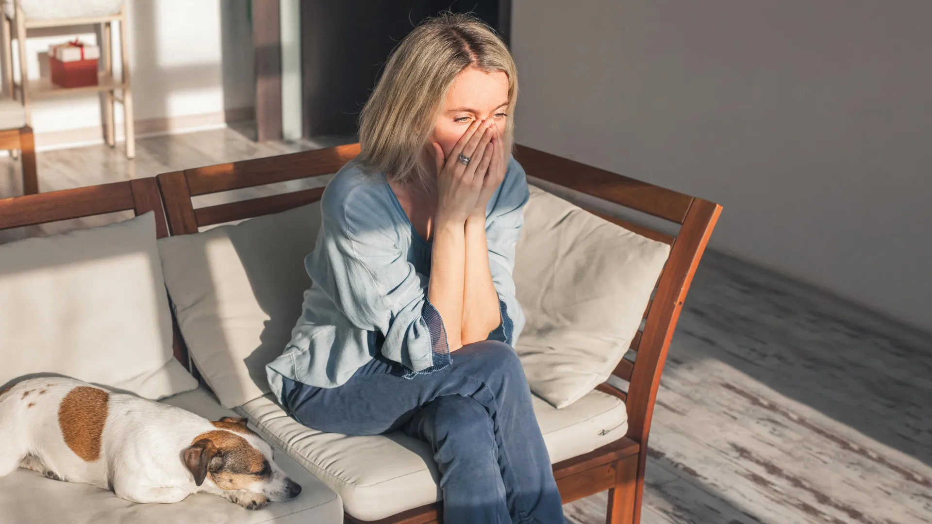 sad woman sitting with dog