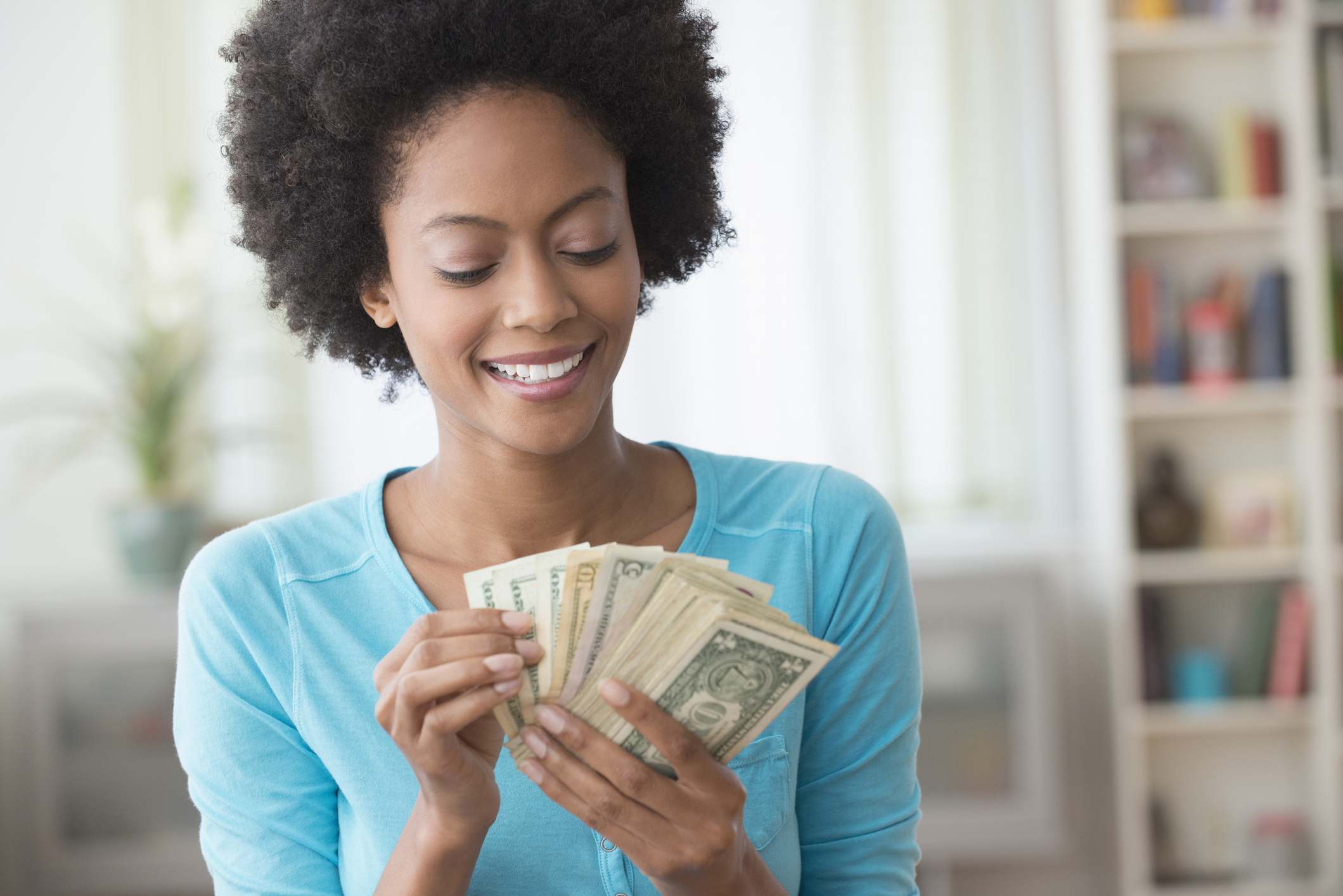 smiling person counting money