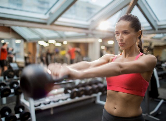 woman kettlebell swings breathing