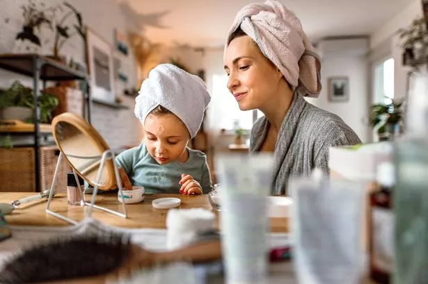 0 Happy mother and daughter enjoying beauty routine together