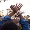 0 Woman with hands raised dancing at music festival