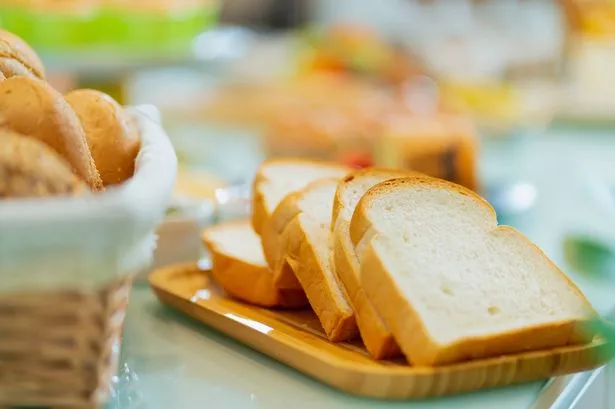 0 close up A loaf of homemade sourdough bread on a chopping board on counter kitchen marble top home interior background
