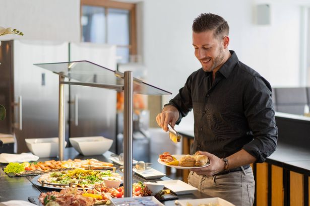 0 business man at hotel restaurant buffet
