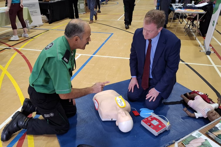 Health Fair brings community together to promote wellbeing 4 Greg Stafford MP learns about using a defibrillator from St Johns ambulance
