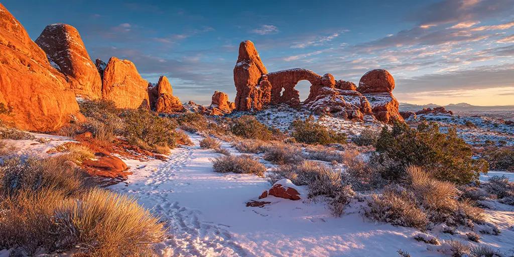 charlesrotter a photo of arches national park at sunset in snow midjourney
