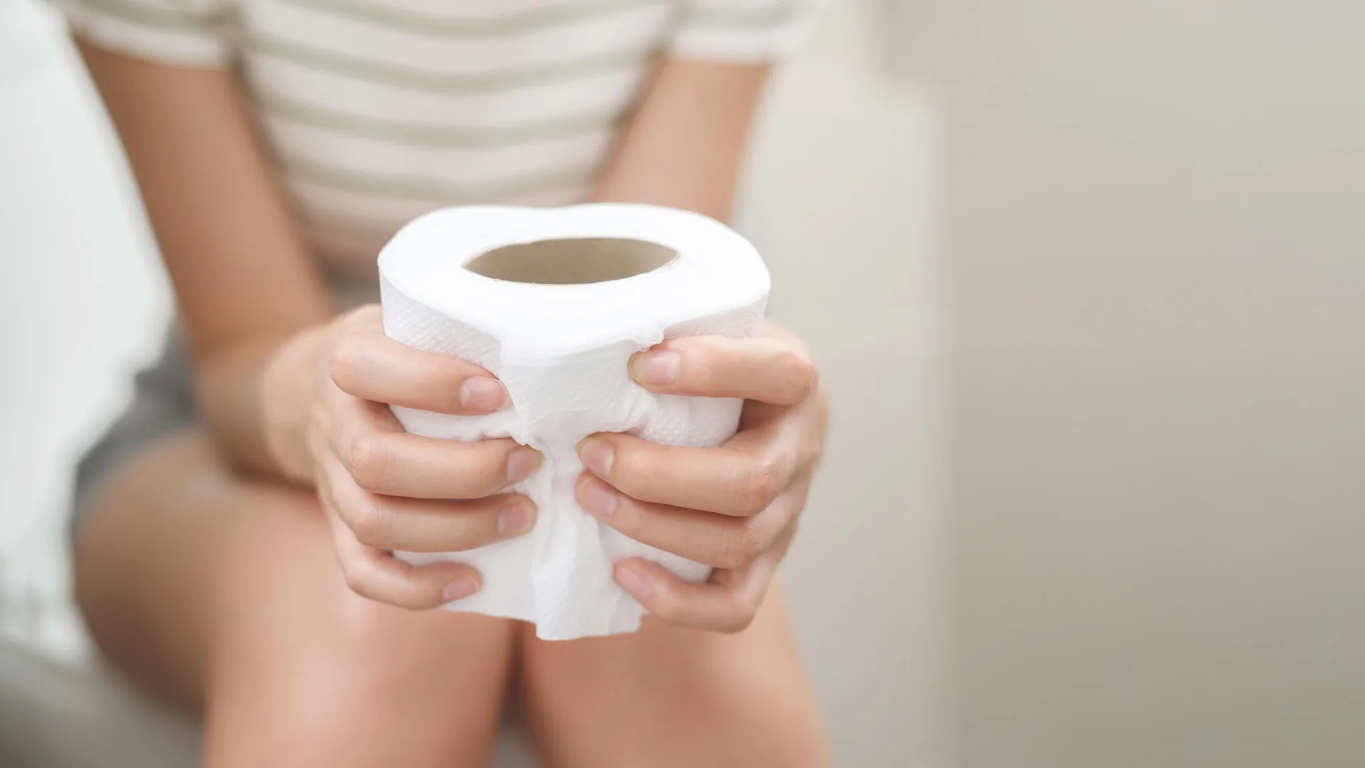woman toilet paper digestion stomach ibs