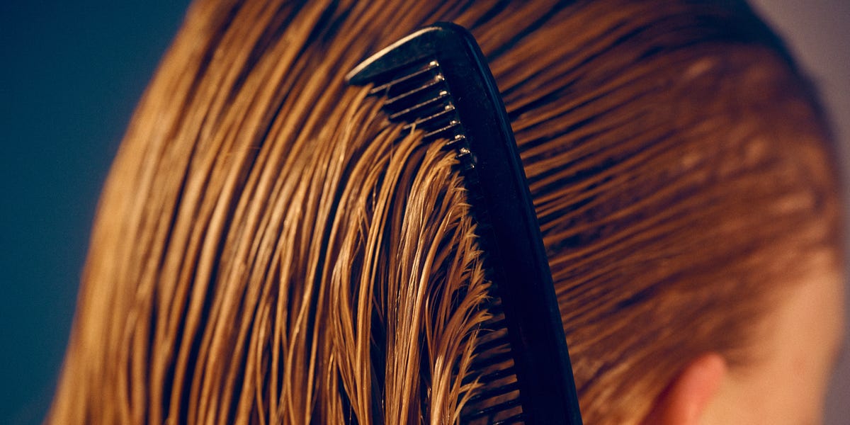 These Hair Conditioners Can Revive Dry, Damaged Strands - ELLE 3 young woman combing wet hair beauty royalty free image 1763070058