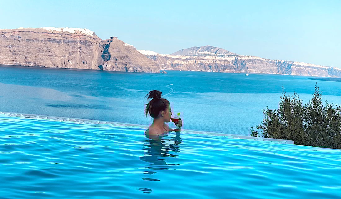 Greece Santorini swimming pools summer girl travel GR Credit Greek Reporter 2