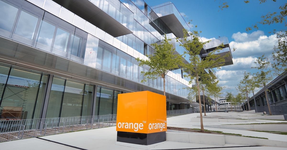 Orange logo outside office in sun