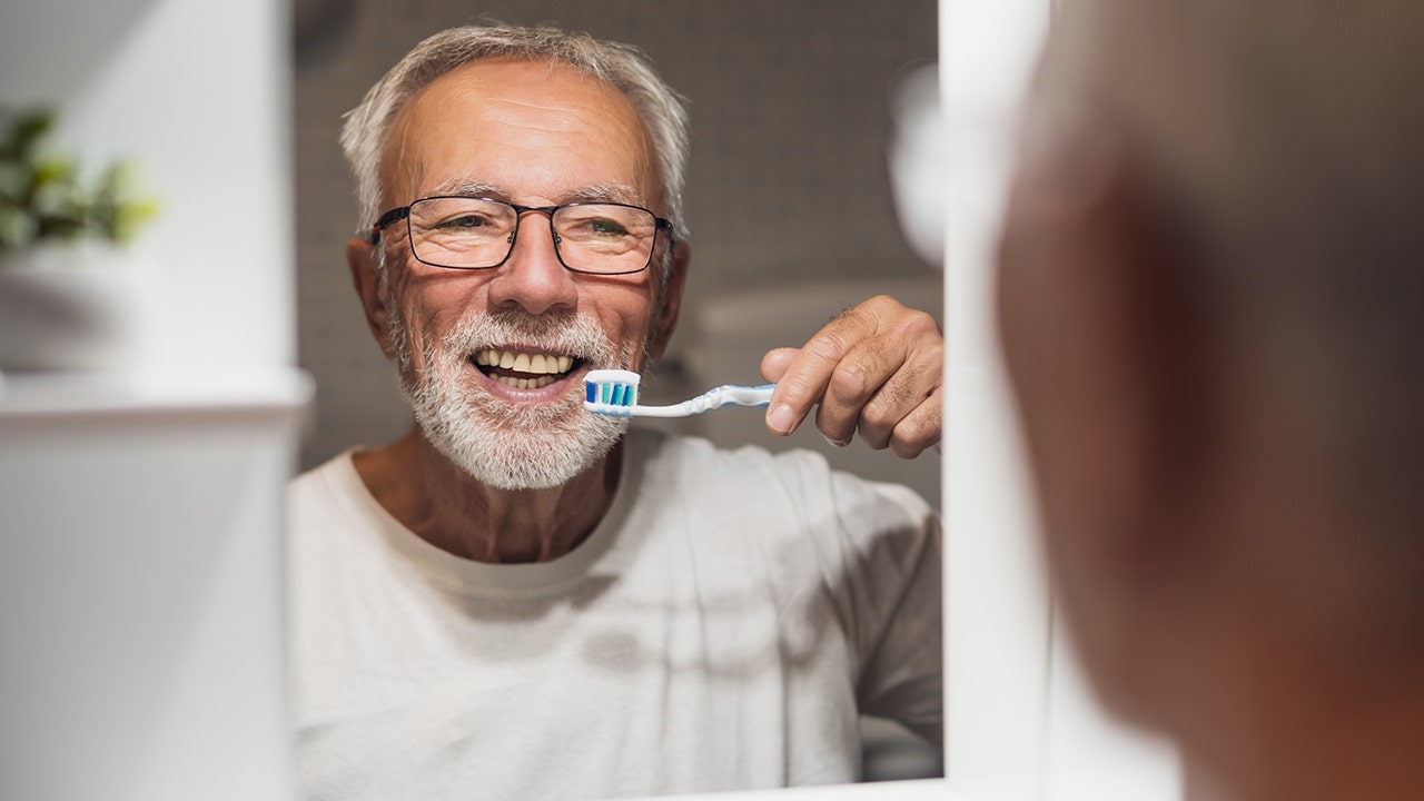 Simple brushing routine could reduce dementia risk, say dental health experts 1 man brushing tteth
