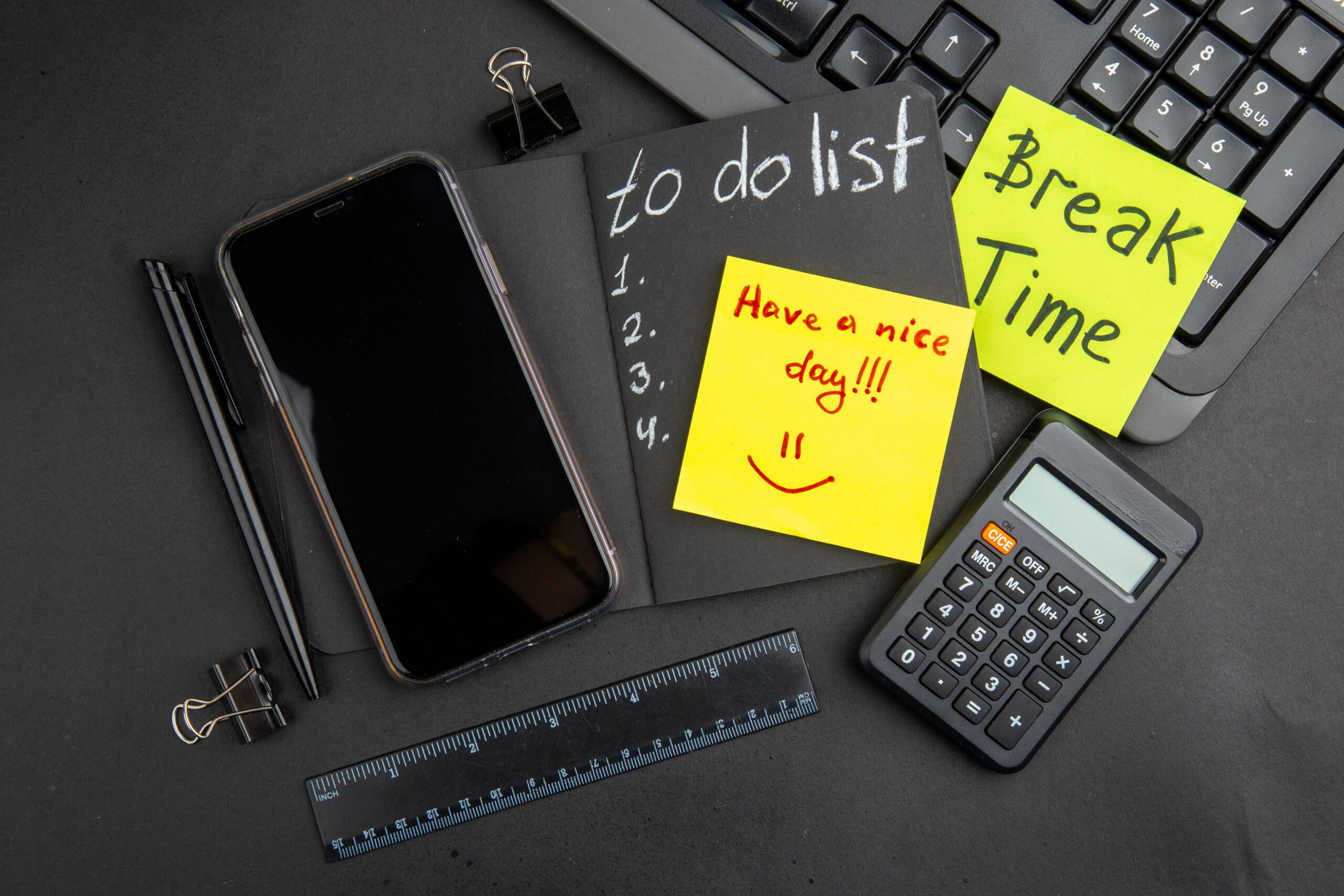 How We Would Start Over: 15 Key Strategies to Reboot Your Productivity 3 top view break time have nice day written sticky notes list black notepad phone pen calculator ruler binder clips keyboard black table scaled 1