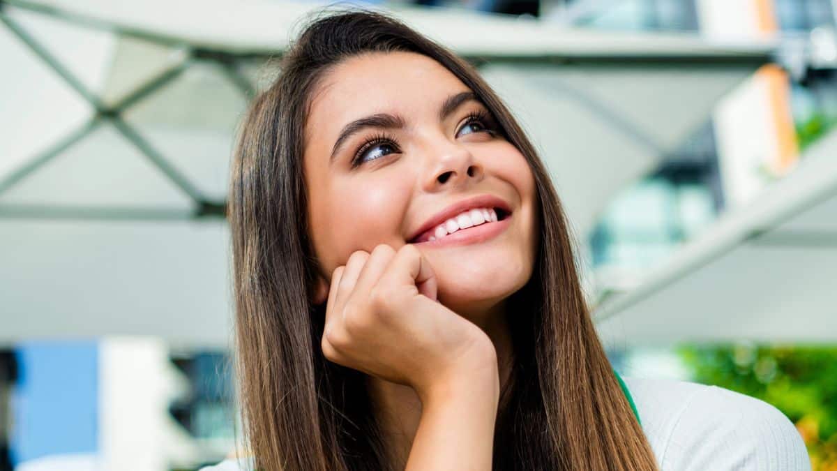 woman smiling outside under tarp