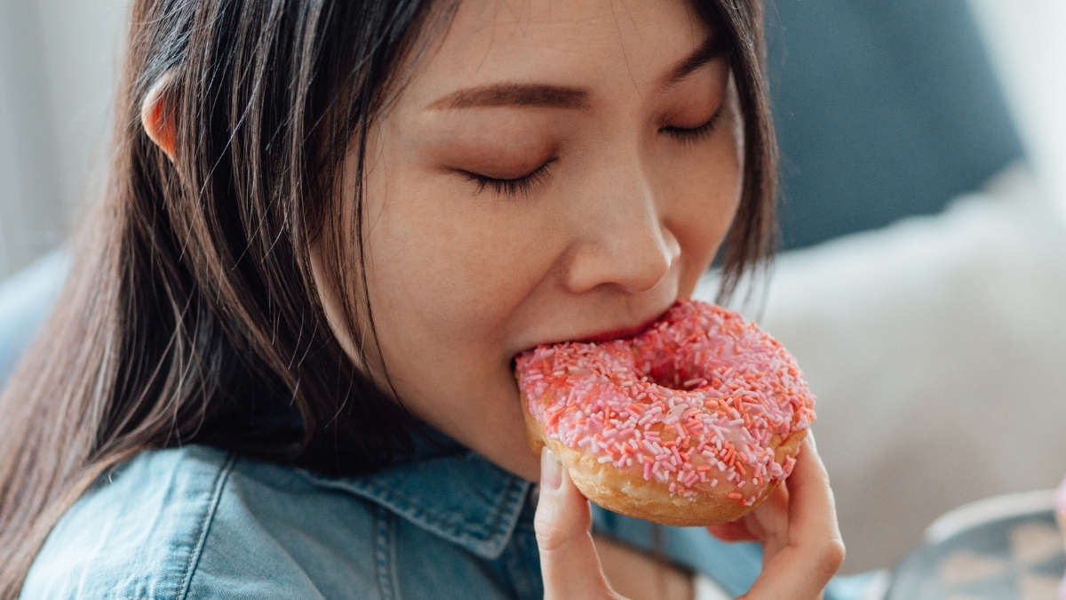 woman eating donut header