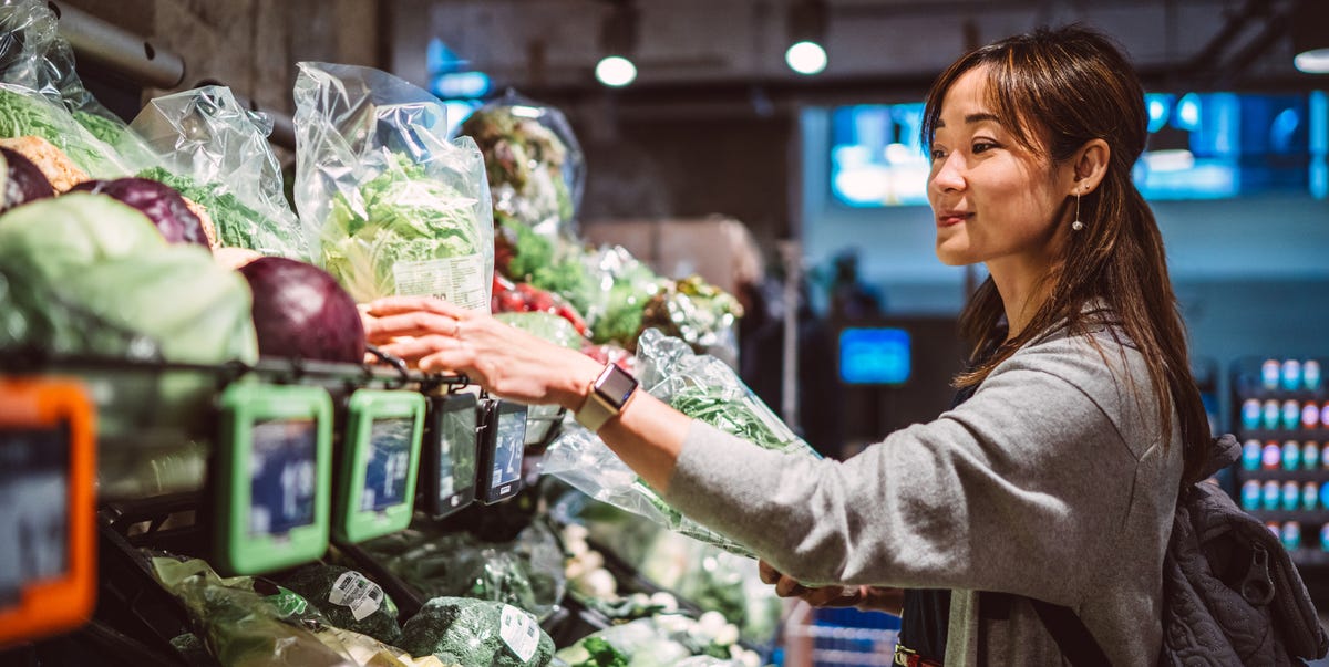 young asian woman shopping for fresh organic royalty free image 1772720928