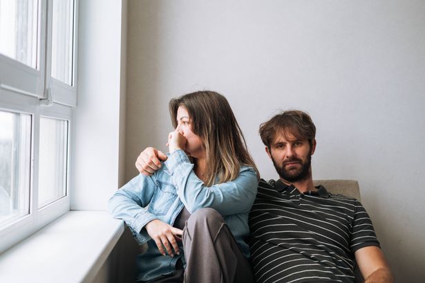 0 Unhappy married couple facing away from each other in a quiet home concept of emotional distance loneliness in