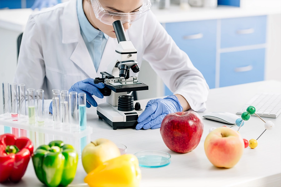 Experts set 2030 nutrition science goals for resilient food systems - Nutrition Insight 3 639113335084448005molecular nutritionist using microscope and sitting at table