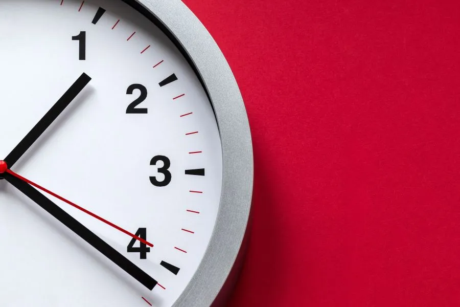 639114182828802217clock in a red wall