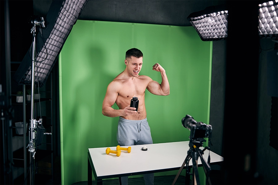 639126294391547158Athletic young man recording video for bodybuilding vlog