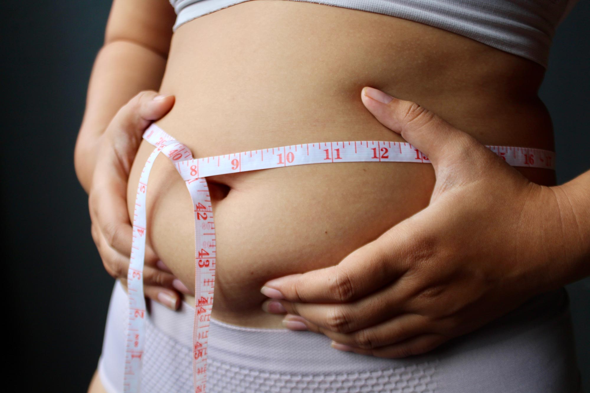 Even Failed Diets May Deliver Long-Term Health Gains, Study Finds - SciTechDaily 2 Belly Fat Weight Loss Woman Measuring Waist Tape Measure