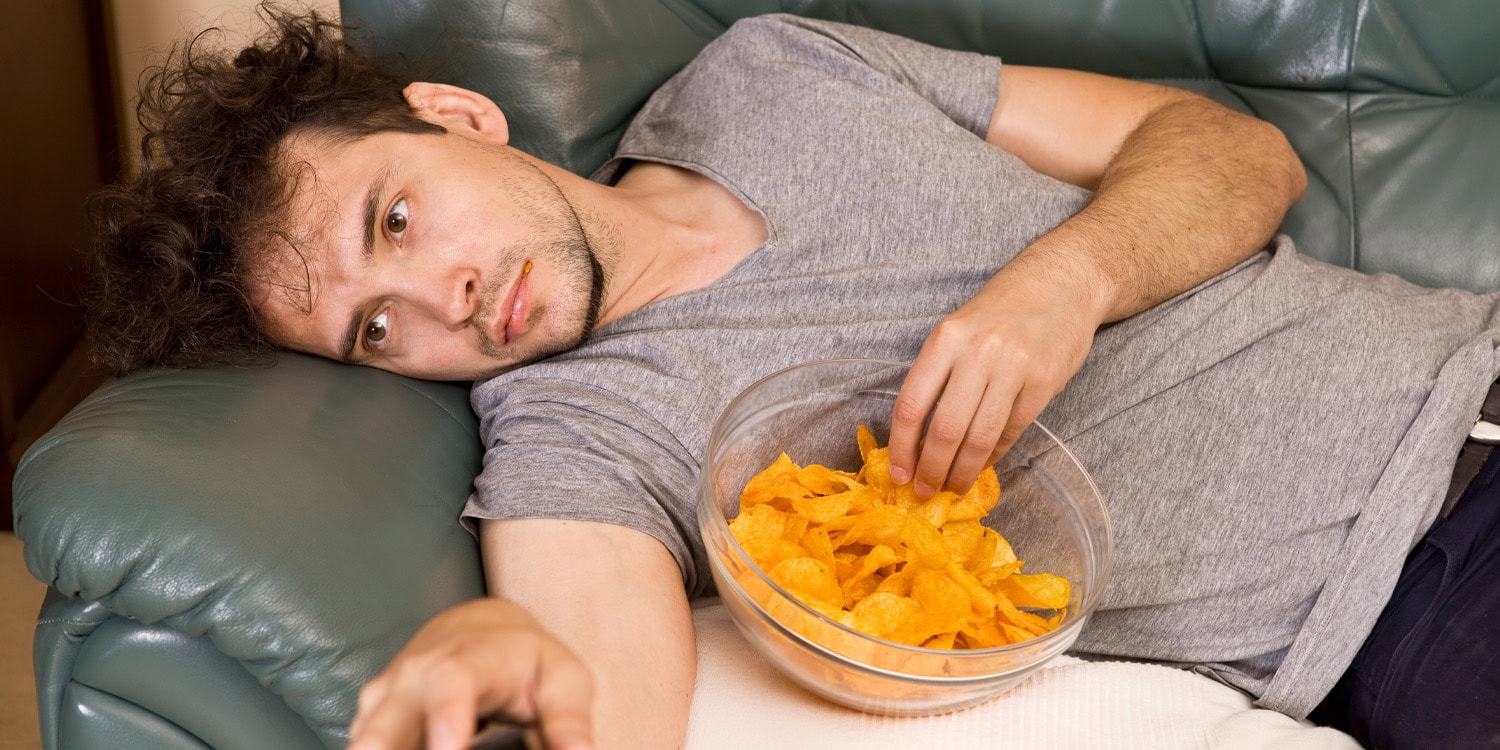 man eating potato chips junk food