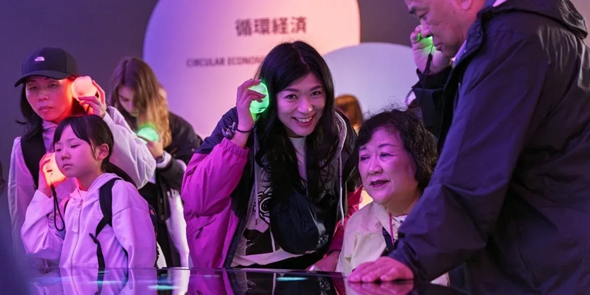 facts and fiction shares creation of German Pavilion at Expo 2025 with new film - Blooloop 5 people listening to audio guides with glowing circulars characters at german pavilion expo 2025 osaka