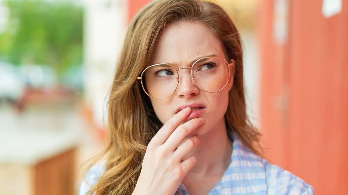 woman nervous wearing glasses