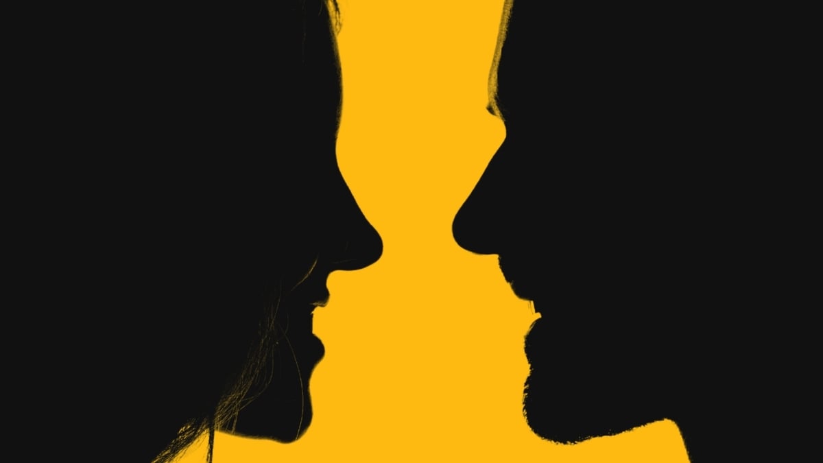 Two silhouetted people facing each other on yellow background