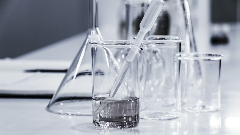 glass beakers with clear liquid chemistry equipment Hans Reniers via Unsplash