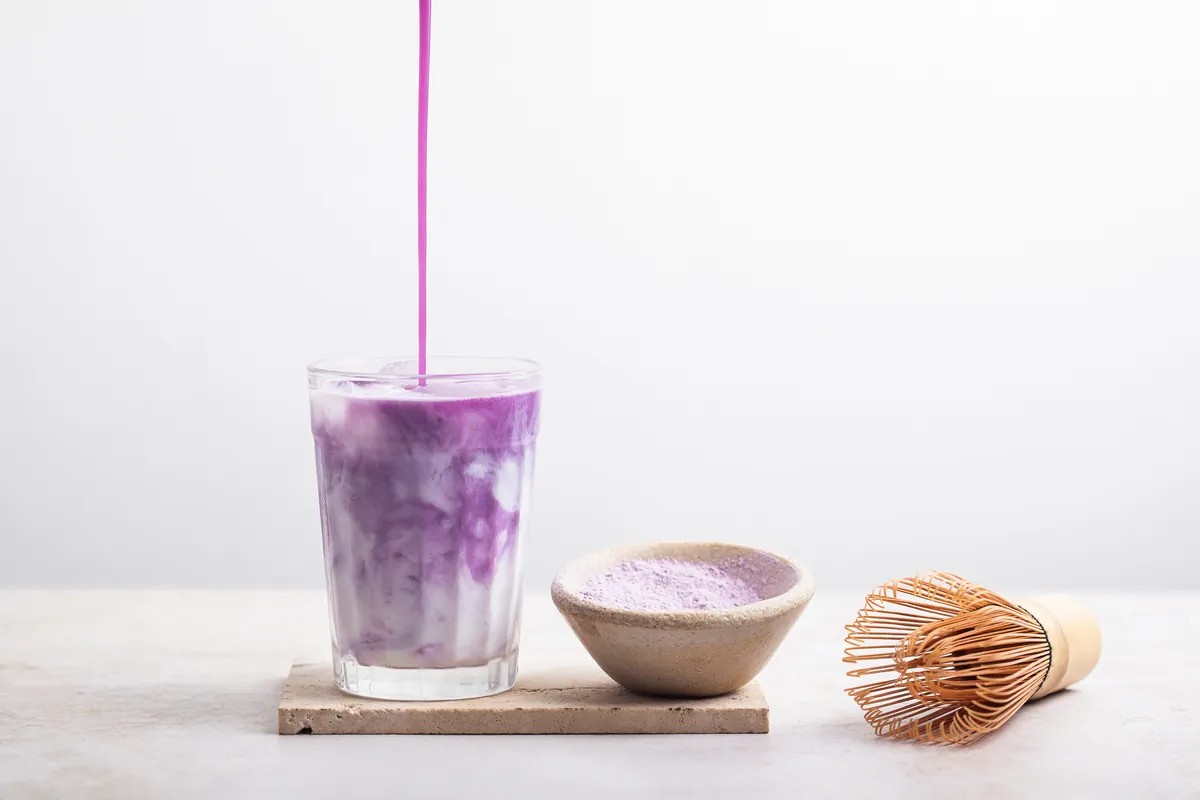 639161872793494461pouring ube flavor in milk in a cup