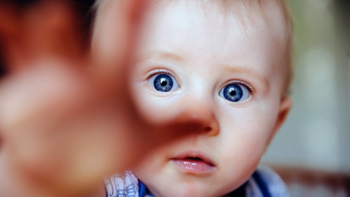 Infant reaches out