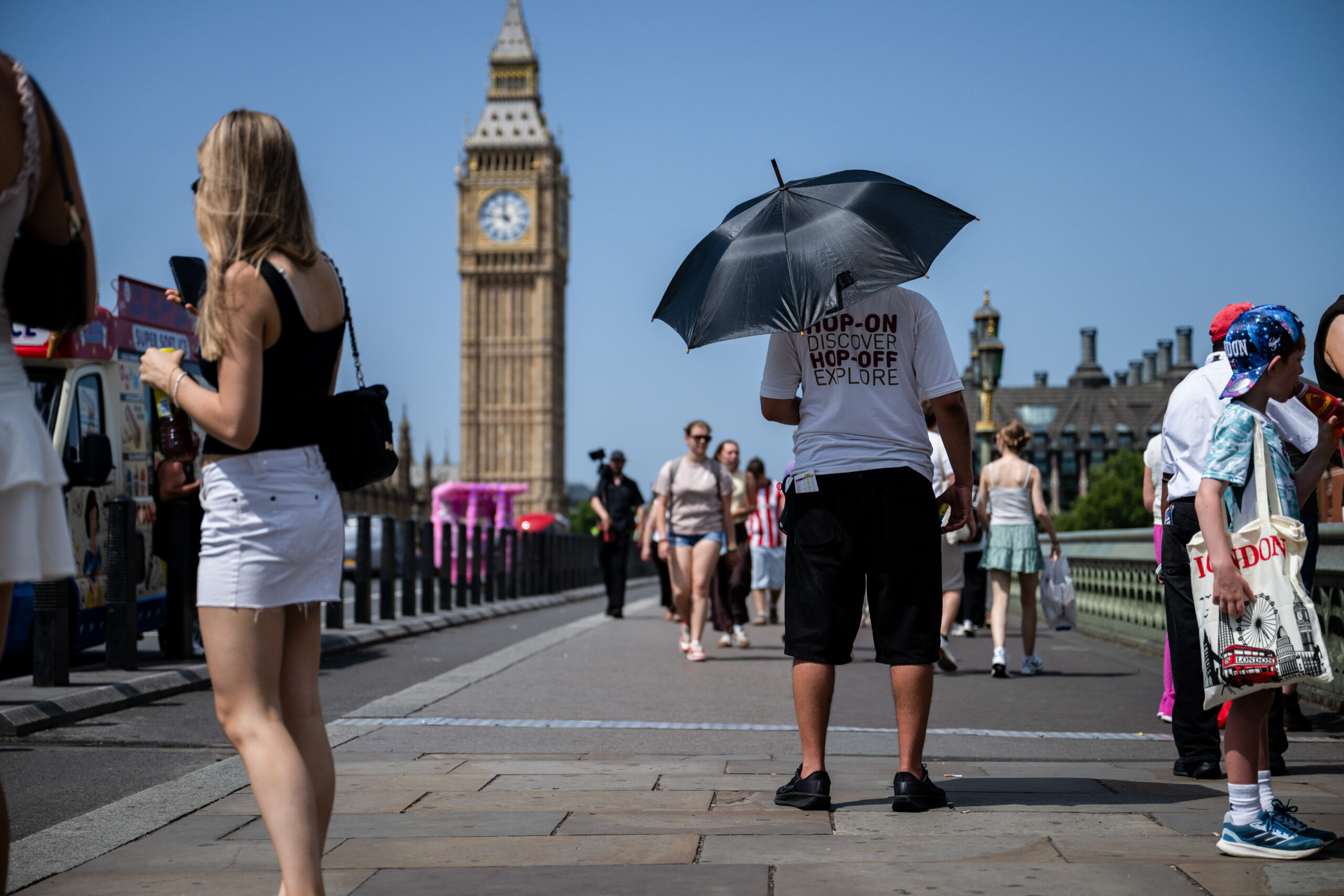 Climate Change Keeps Adding to the List of Uninsurable Assets, Allianz Executive Says 3 tour bus employee on westminster bridge in london bloomberg scaled 1